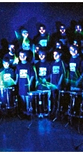 Drum Club performing  with glow sticks at night